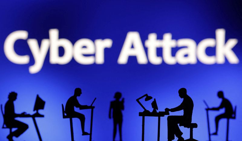 © Reuters. FILE PHOTO: Figurines with computers and smartphones are seen in front of the words