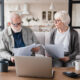 A senior couple dealing with unexpected Social Security taxes, commonly referred to as the Social Security tax torpedo.