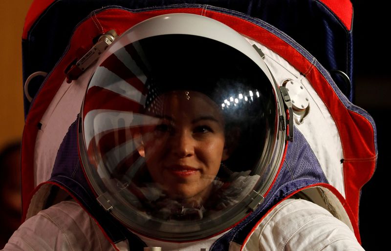 © Reuters. FILE PHOTO: Advanced Space Suit Engineer at NASA Kristine Davis wears the xEMU prototype space suit for the next astronaut to the moon by 2024,  during its presentation at NASA headquarters in Washington, U.S., October 15, 2019. REUTERS/Carlos Jasso/File Photo