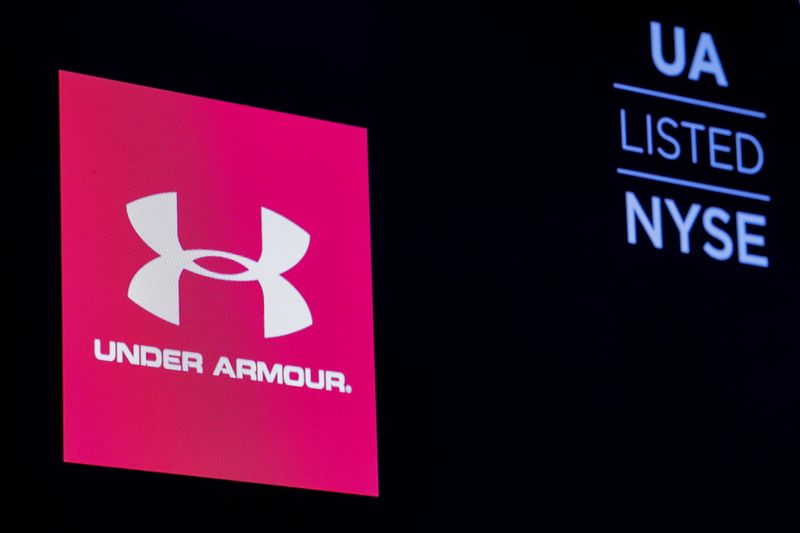 © Reuters. FILE PHOTO: The ticker symbol and company logo for Under Armour, Inc. is displayed on a screen on the floor of the New York Stock Exchange (NYSE) in New York, U.S., January 22, 2019. REUTERS/Brendan McDermid/File Photo