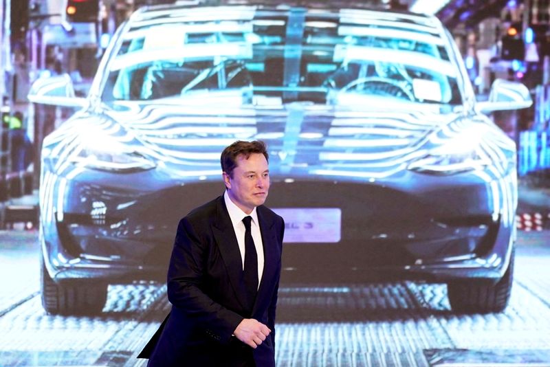 © Reuters. FILE PHOTO: Tesla Inc CEO Elon Musk walks next to a screen showing an image of Tesla Model 3 car during an opening ceremony for Tesla China-made Model Y program in Shanghai, China January 7, 2020. REUTERS/Aly Song//File Photo