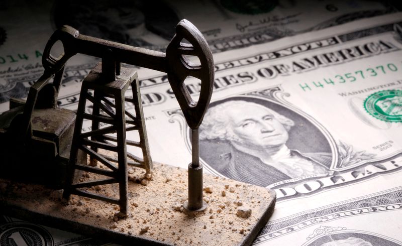 FILE PHOTO: A 3D-printed oil pump jack is placed on dollar banknotes in this illustration picture