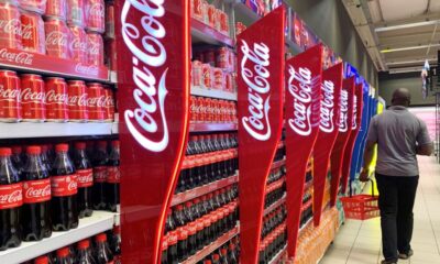 © Reuters. FILE PHOTO: A man walks past shelves of Coca-Cola bottles and cans at a Shoprite store inside Palms shopping mall in Lagos, Nigeria November 5, 2019. REUTERS/Temilade Adelaja/File Photo