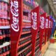 © Reuters. FILE PHOTO: A man walks past shelves of Coca-Cola bottles and cans at a Shoprite store inside Palms shopping mall in Lagos, Nigeria November 5, 2019. REUTERS/Temilade Adelaja/File Photo