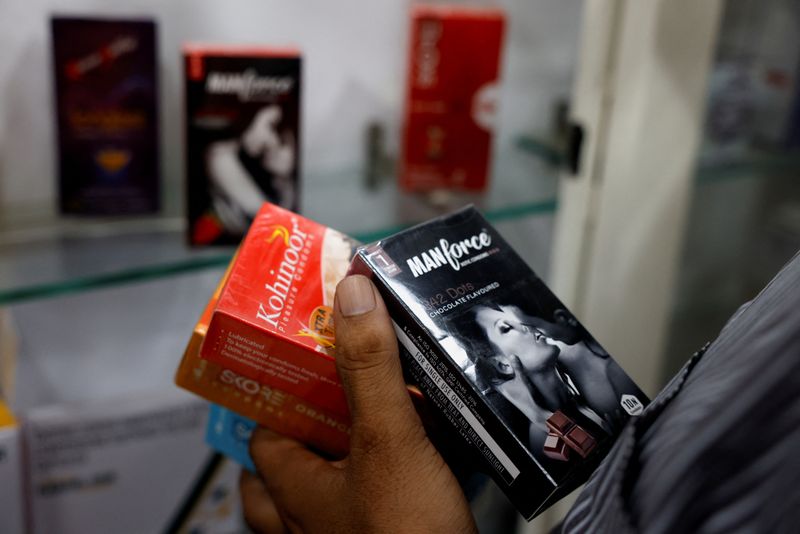 © Reuters. FILE PHOTO: A man selects packets of condoms that are displayed for sale at a chemist shop in Ahmedabad, India, September 2, 2024. REUTERS/Amit Dave/File Photo