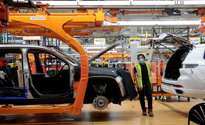 Stellantis assembly workers work on assembling the 2021 Jeep Grand Cherokee L