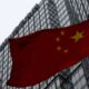 © Reuters. FILE PHOTO: A building housing the PricewaterhouseCoopers (PWC) branch office stands behind a Chinese national flag in Beijing January 24, 2014.  REUTERS/Kim Kyung-Hoon/File Photo