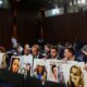 © Reuters. FILE PHOTO: Family members hold photographs of Boeing 737 MAX crash victims lost in two deadly 737 MAX crashes that killed 346 people as they wait for then Boeing CEO Dennis Muilenburg to testify before a Senate Commerce, Science and Transportation Committee hearing on “aviation safety” and the grounded 737 MAX on Capitol Hill in Washington, U.S., October 29, 2019. REUTERS/Sarah Silbiger/File Photo